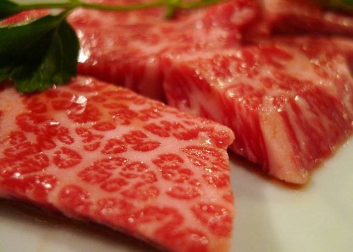 High-quality cuts of wagyu beef, shiny with marbling and juicy meat.